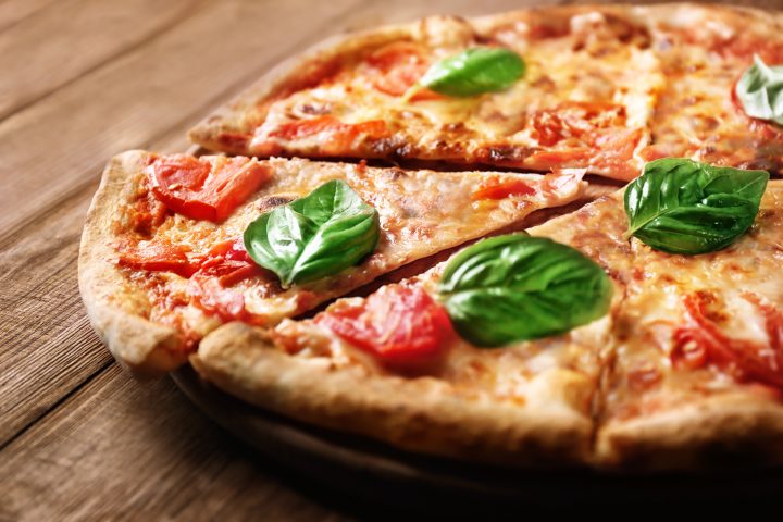 Delicious Pizza With Tomatoes And Fresh Basil On Wooden Backgrou