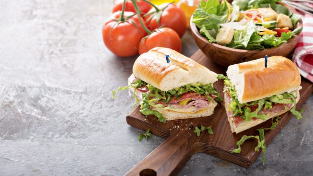 Sub Salad And Salad on a cutting board.