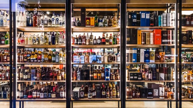 Liquor Store Shelves Behind Glass