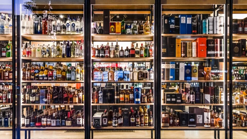 Liquor Store Shelves Behind Glass