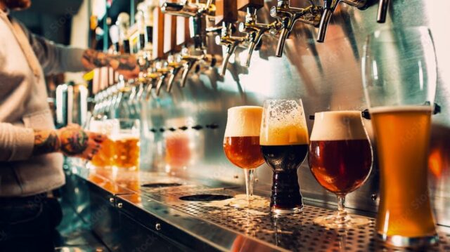 several beers on tap being poured.