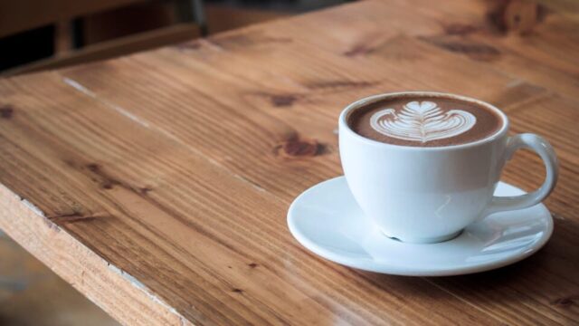 A cup of coffee on a table.
