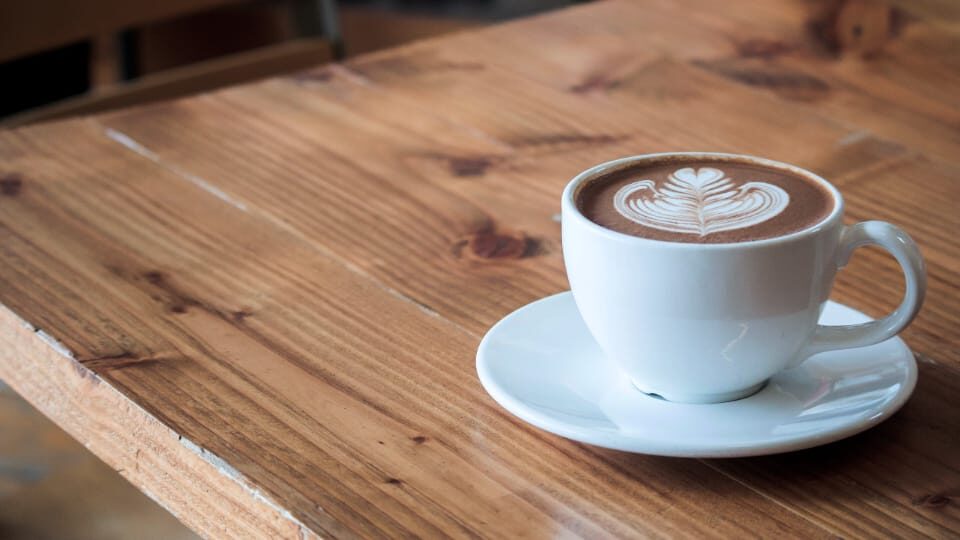 A cup of coffee on a table.